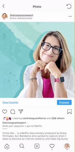 Sue B Zimmerman smiles from her Instagram photo that has a bright blue background. 