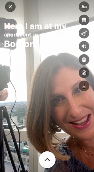 Sue B Zimmerman looks into the camera as she records and autocaptions an Instagram Story video.